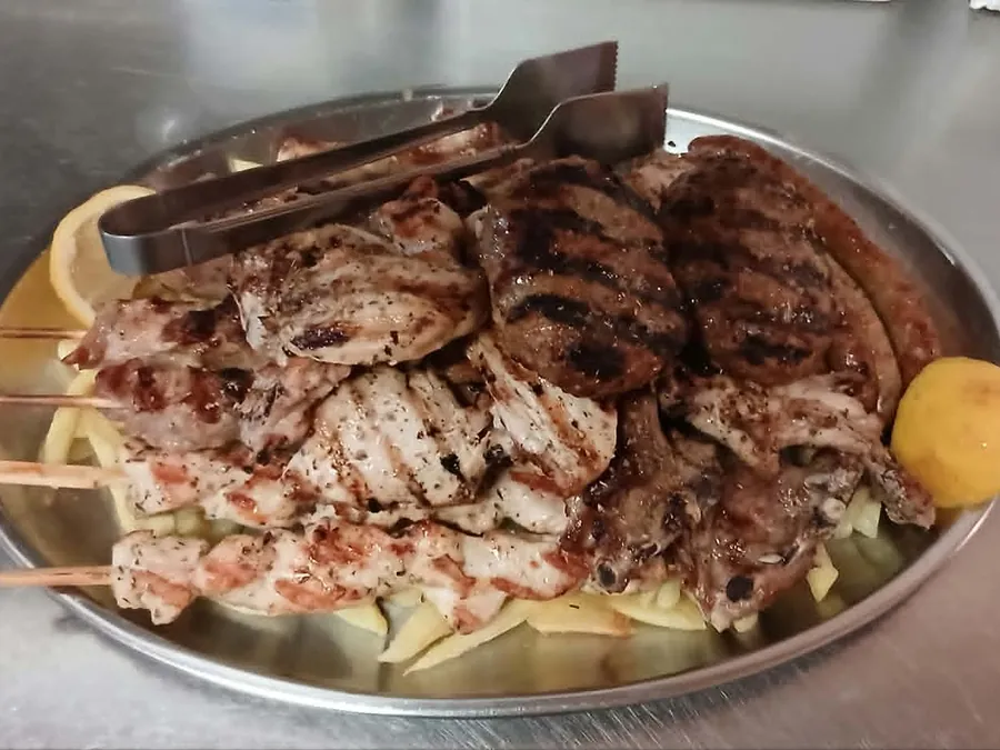 Large mixed grill platter with souvlaki, patties, sausage and chops