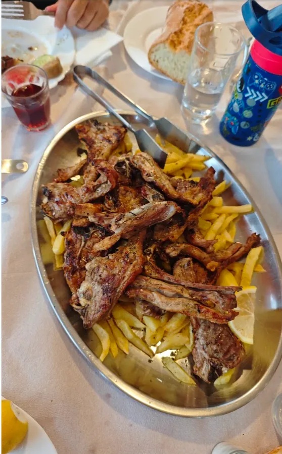 A platter of lamb chops with fries